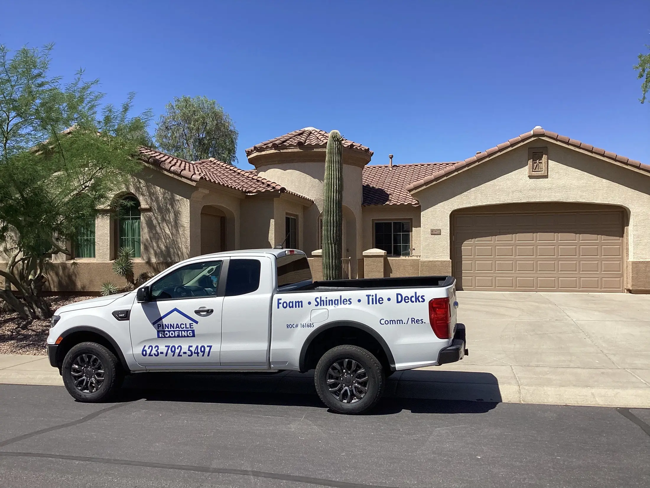 Pinnacle Roofing truck in front of a tile-roofed home in Anthem, Arizona