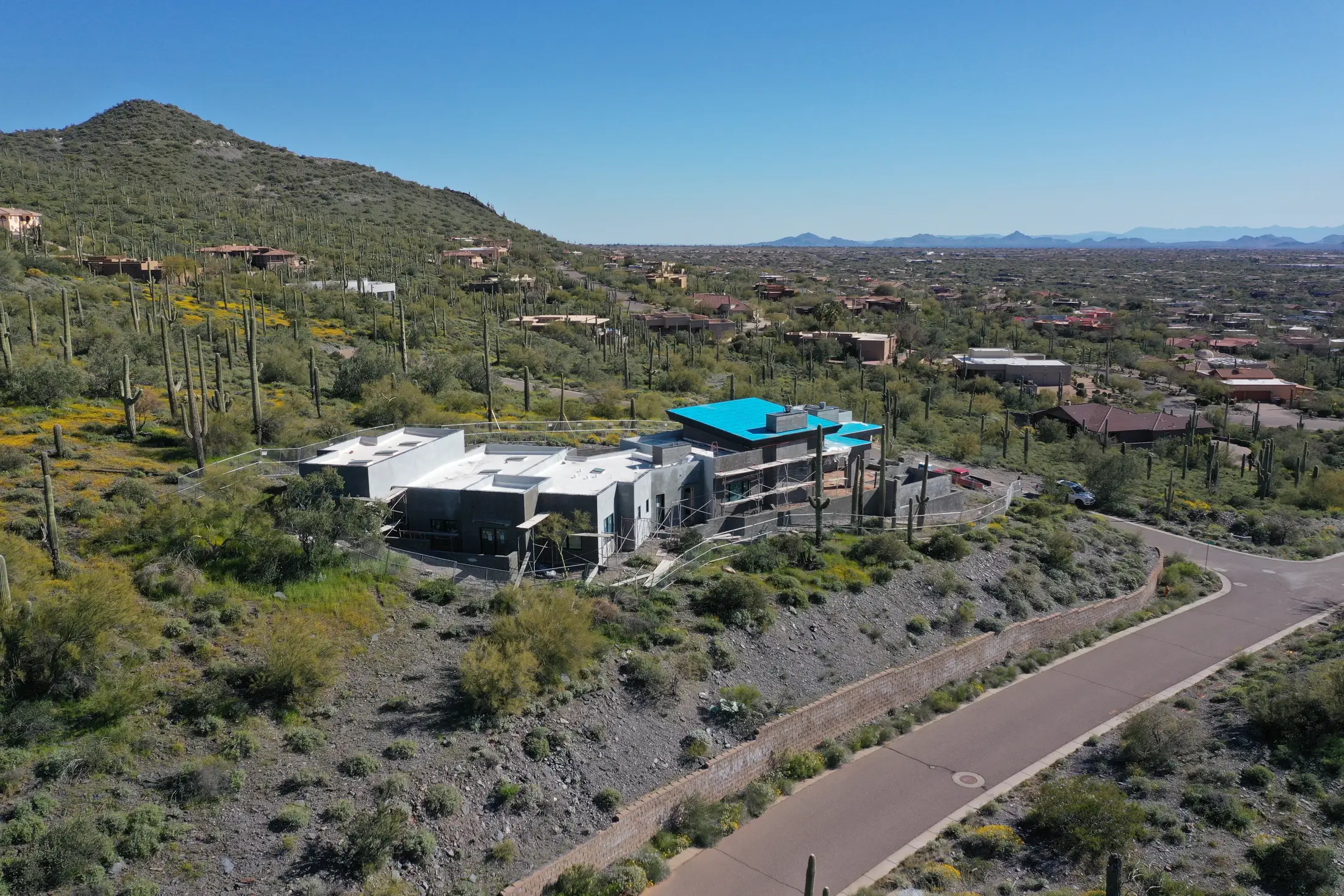 Aerial view of a luxury desert home with flat rooflines