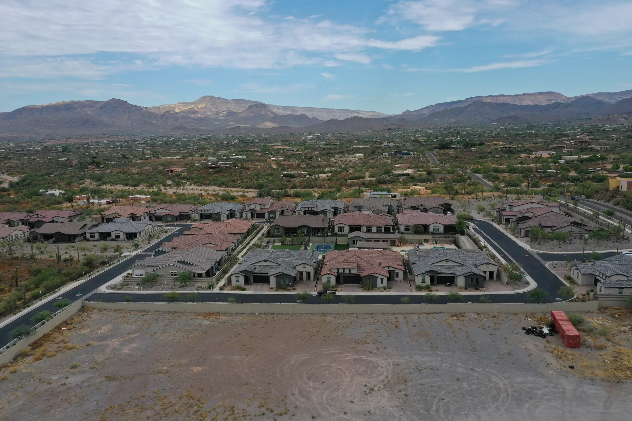 Drone view of a tile-roofed neighborhood at the desert edge