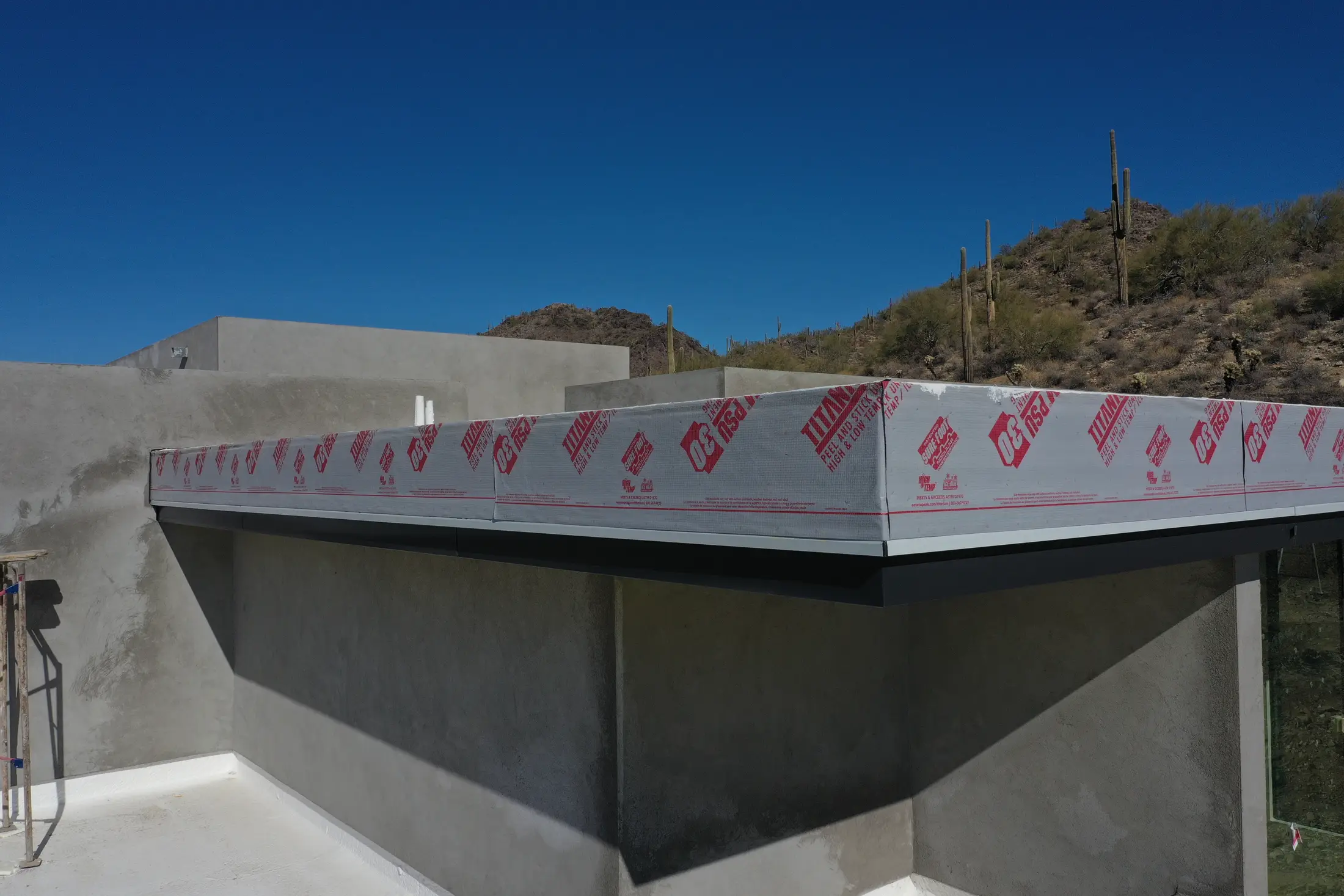 Flat roof parapet prepared with high-temperature underlayment on a Pinnacle job
