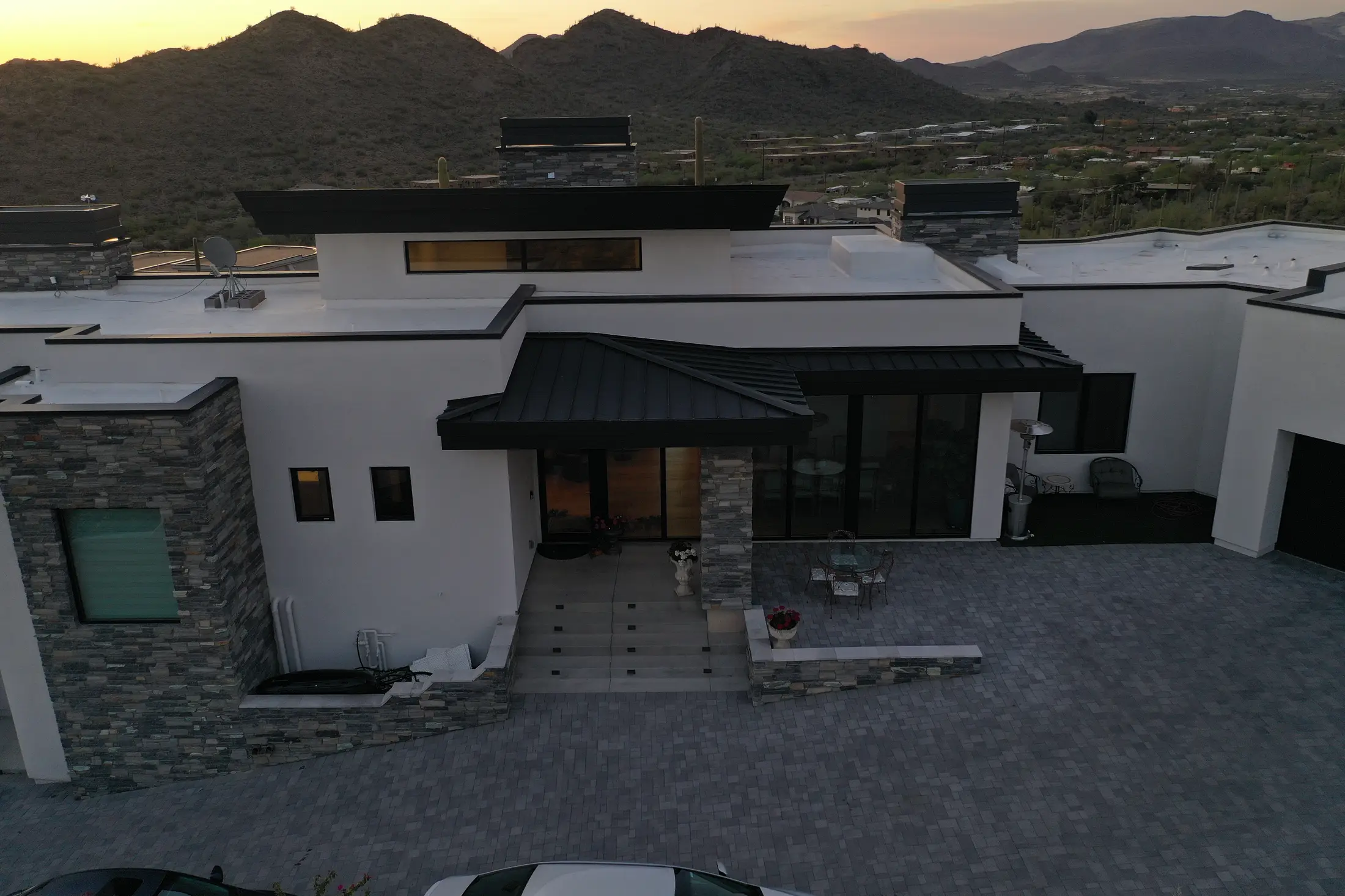 Modern Phoenix-area home with metal roofing accents at dusk
