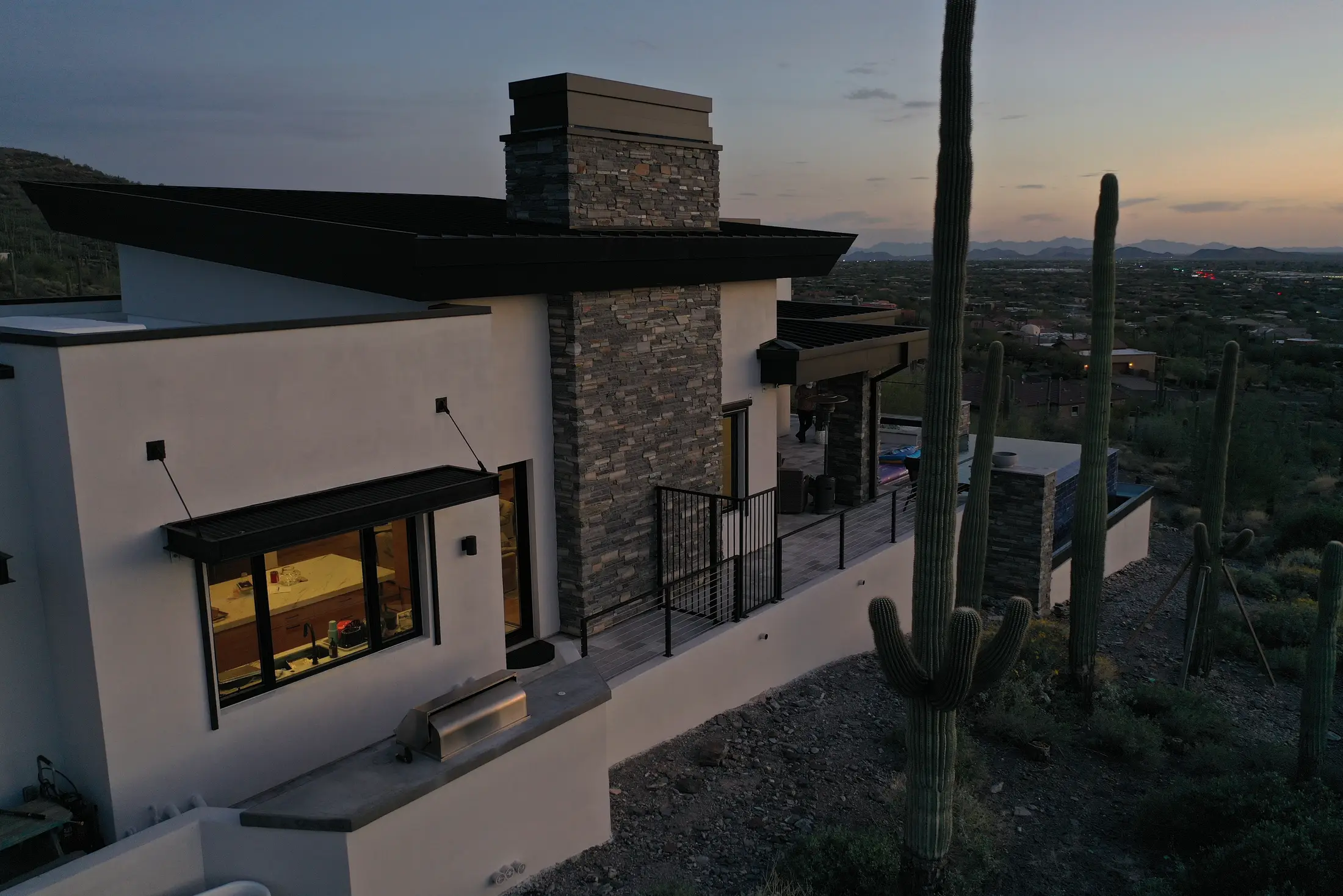 Custom desert home with metal roof details at dusk