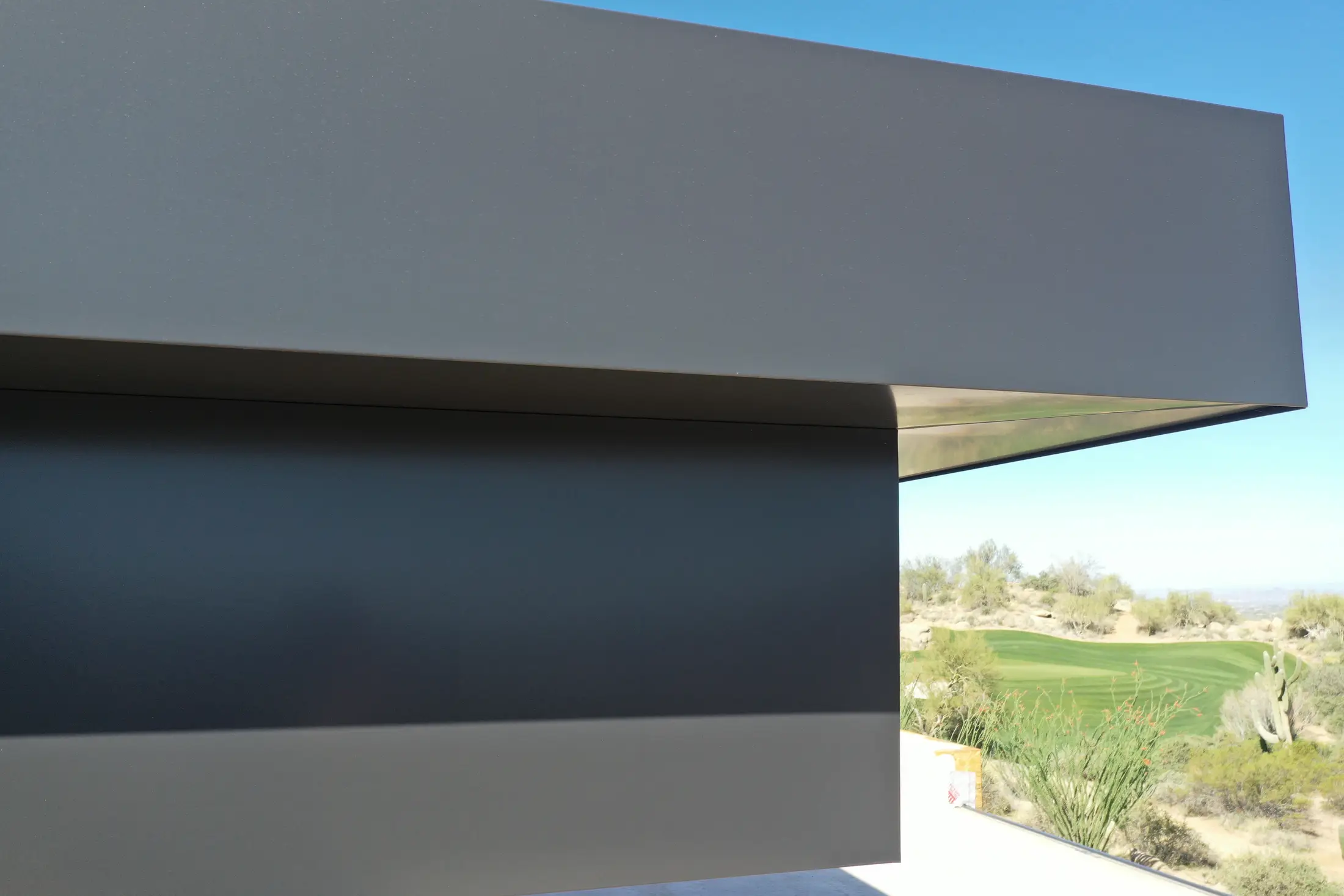 Dark metal roof edge and fascia detail on a modern home