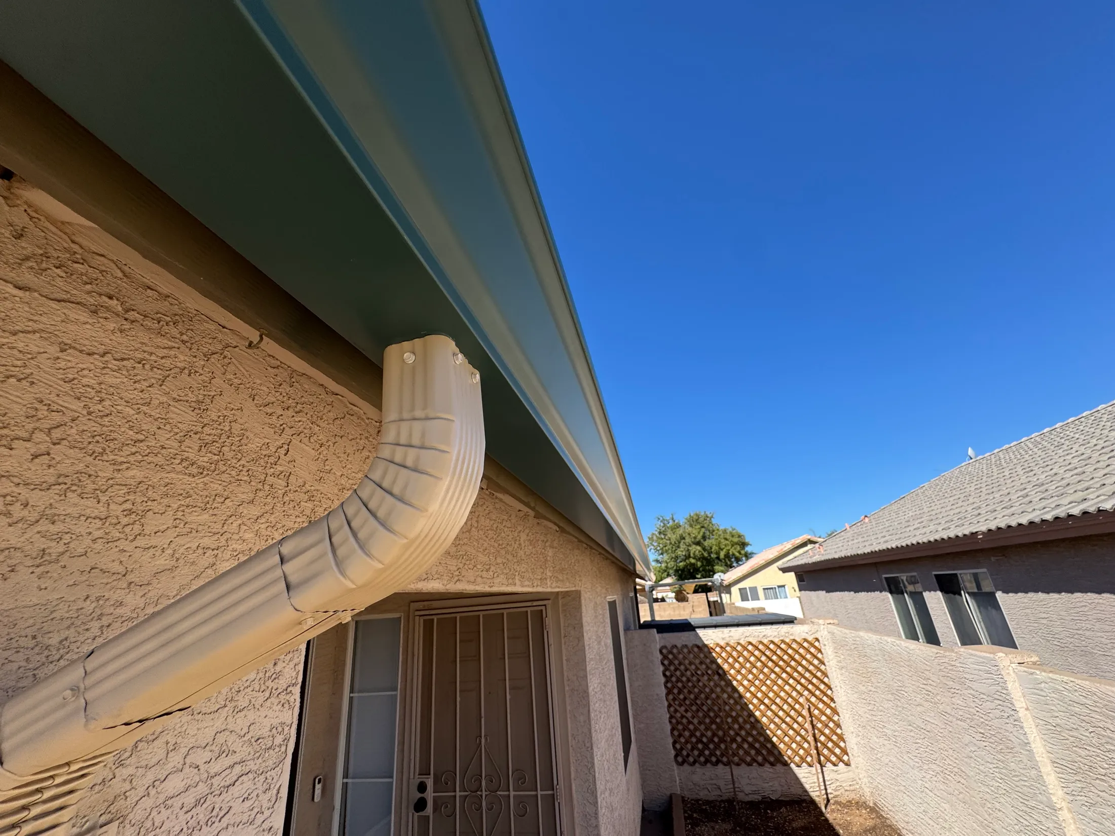 New downspout and seamless gutter installed on a Phoenix home