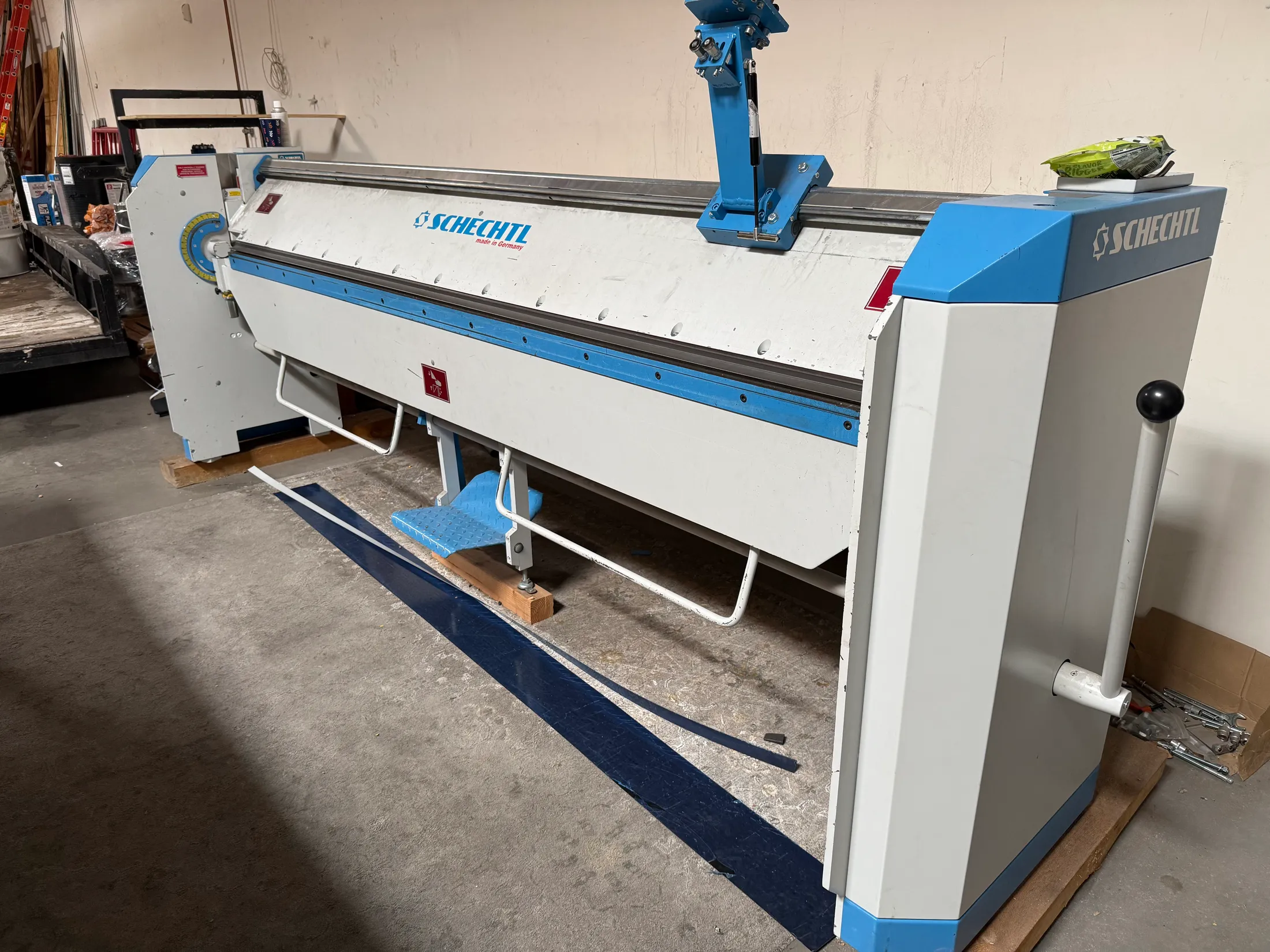 Full-size metal brake in the Pinnacle Roofing fabrication shop