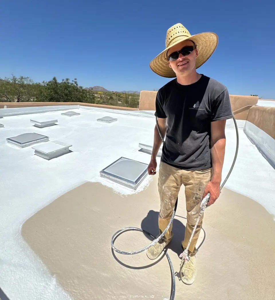 Protective coating being applied to a large flat commercial roof
