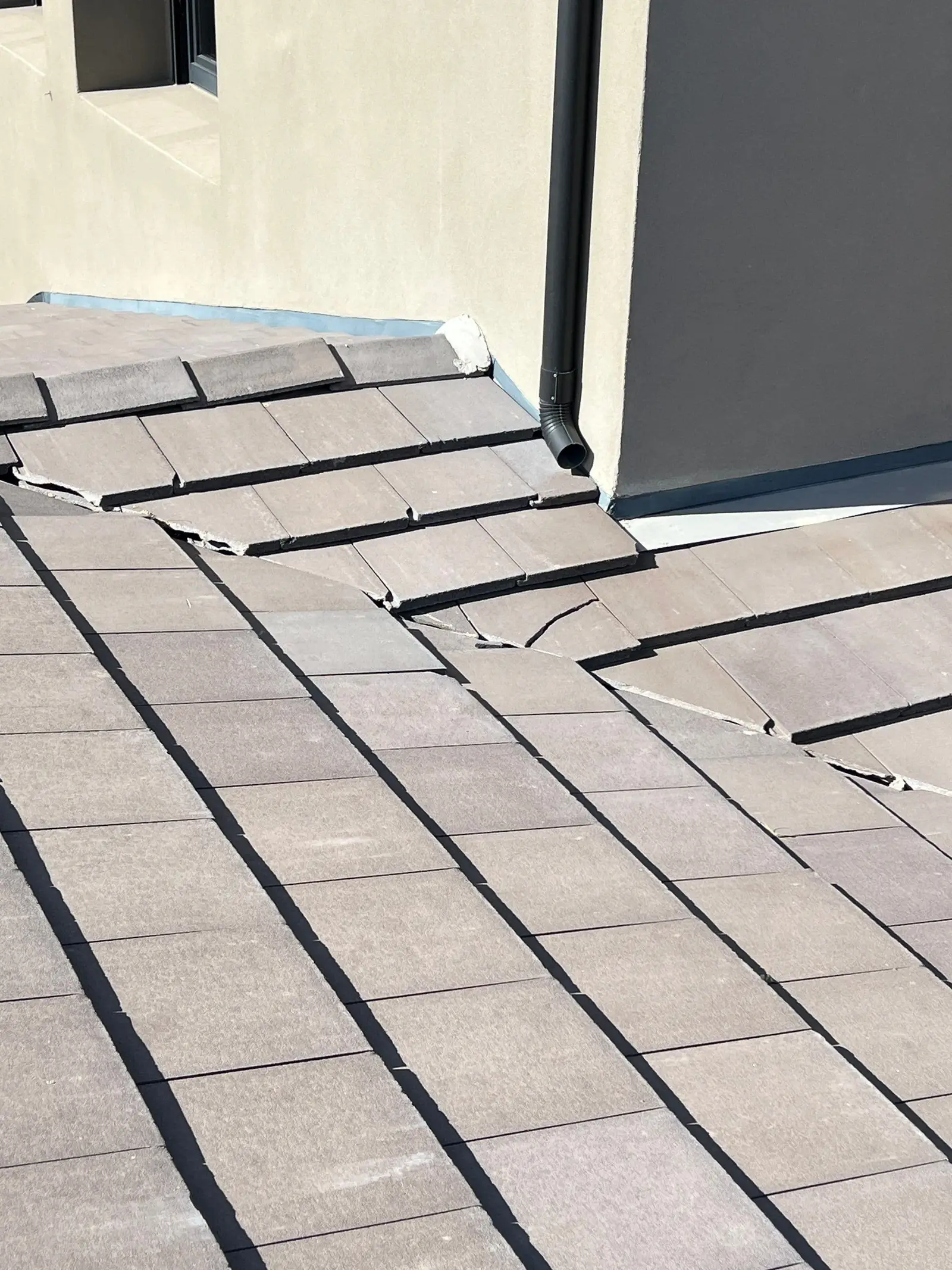 Roofer inspecting a tile roof