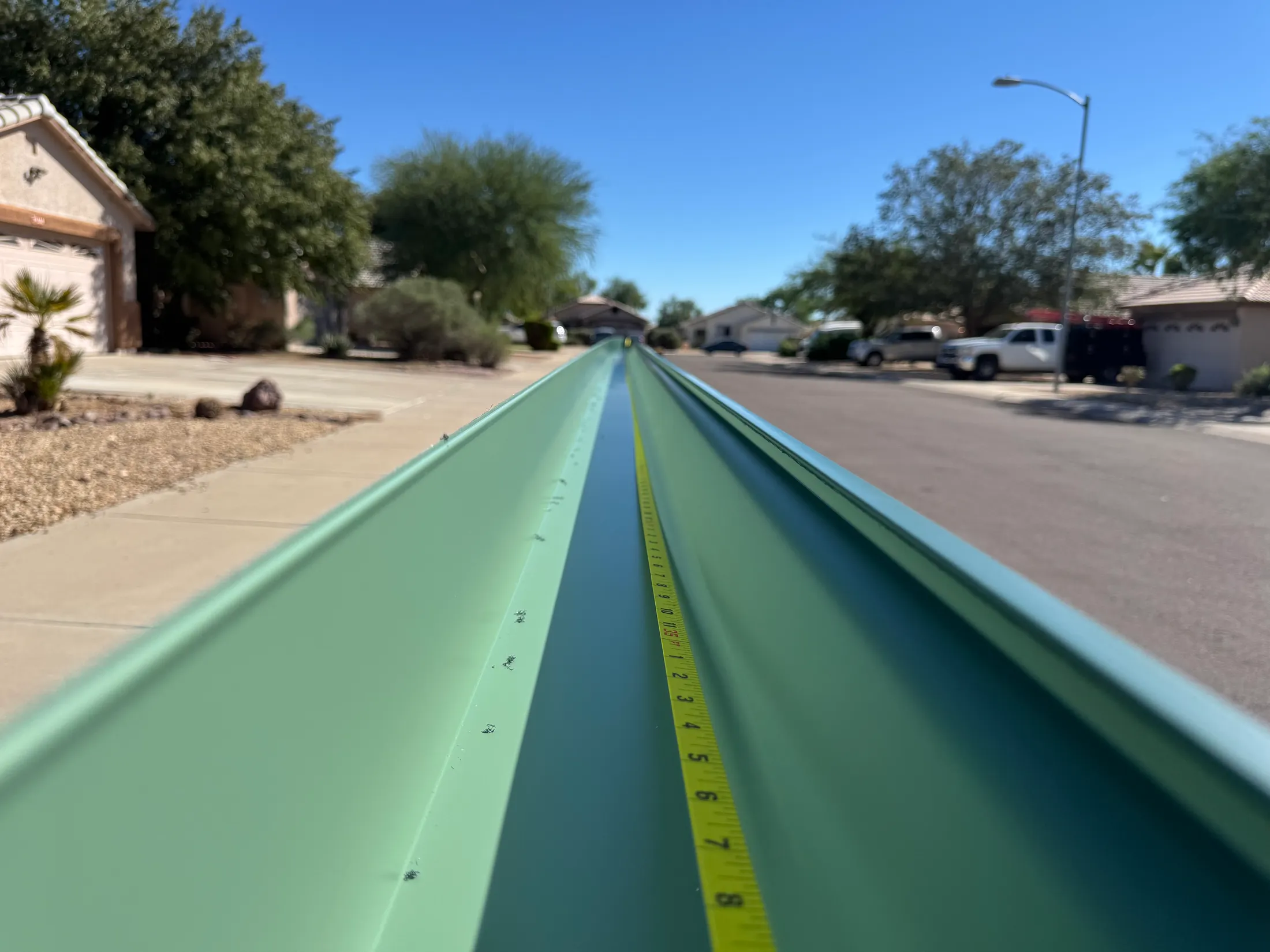 Freshly formed seamless gutter run laid out ready for installation