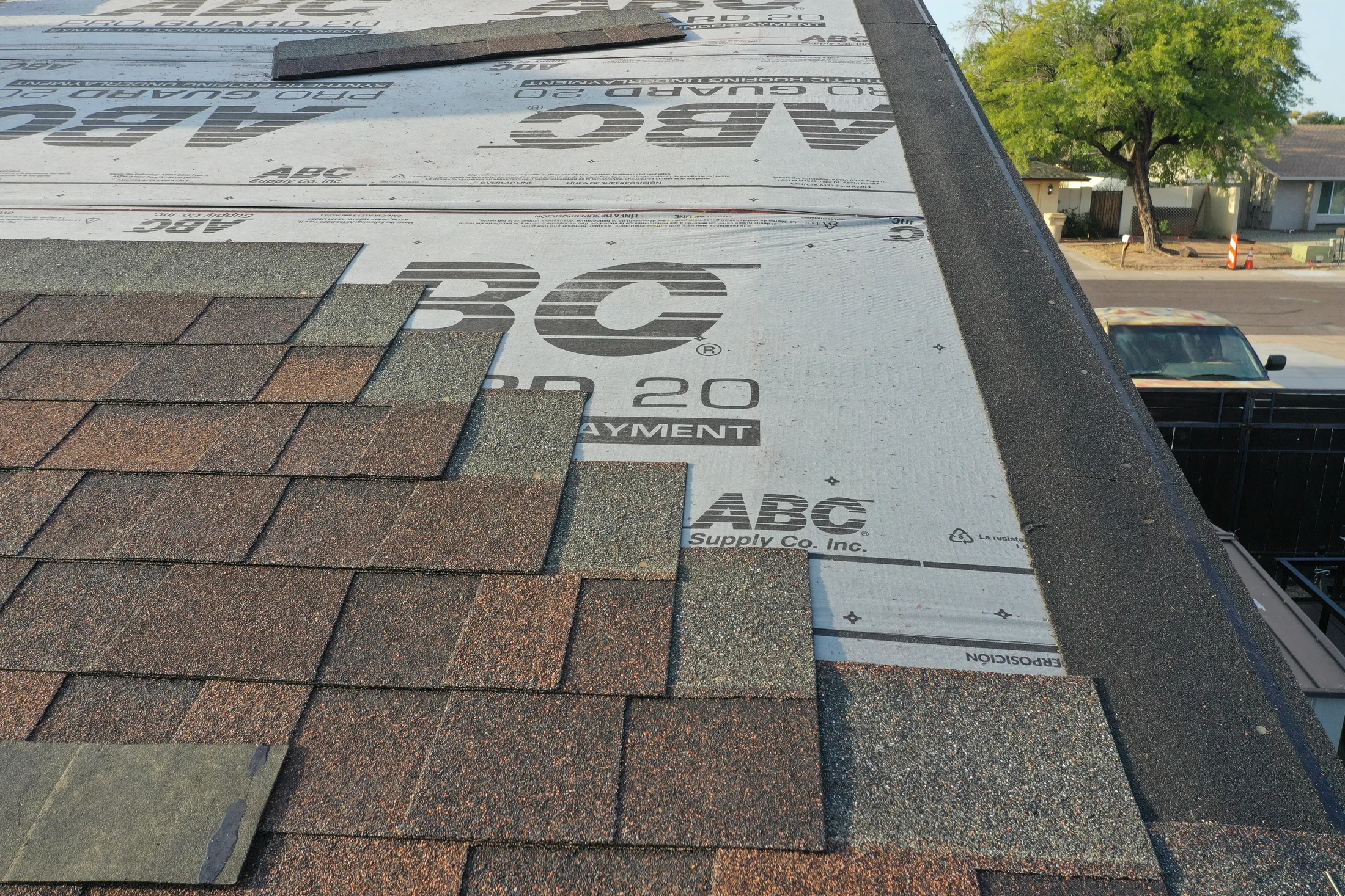 New architectural shingles being installed over fresh underlayment on a Phoenix roof