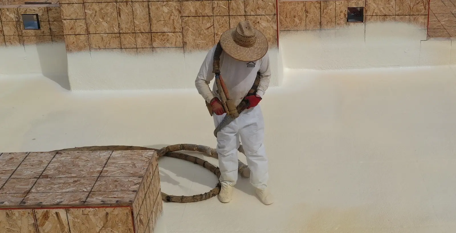 Spray polyurethane foam being applied to a flat roof